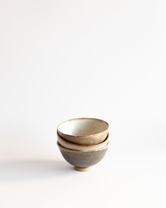 Three wheel-thrown ceramic bowls with black and white glaze